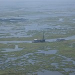 Wetlands and oil rig. Photo Credits: Lynn Miller