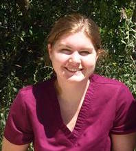 Headshot of Katie McInnis wearing magenta scrubs.